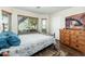 Comfortable bedroom featuring wood floors, a large window, and a TV on a wooden cabinet at 4887 E Armor St, Cave Creek, AZ 85331