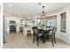 Dining area with white cabinets, stainless steel appliances, and a view of the well lit dining area at 4887 E Armor St, Cave Creek, AZ 85331