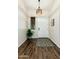 Foyer features wood floors, a patterned area rug, and a white front door with an overhead light fixture at 4887 E Armor St, Cave Creek, AZ 85331