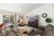 Spacious living room boasts a leather sofa, a ceiling fan, and a sliding glass door leading to the pool at 4887 E Armor St, Cave Creek, AZ 85331