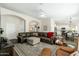 Comfortable living room with a leather sofa, ceiling fan, and open access to the dining area and kitchen at 4887 E Armor St, Cave Creek, AZ 85331