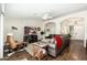 Inviting living room featuring a leather sofa, ceiling fan, and an open floorplan flowing into other living areas at 4887 E Armor St, Cave Creek, AZ 85331