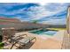 Backyard pool with tanning deck, lush landscaping, and outdoor lounging area at 4887 E Armor St, Cave Creek, AZ 85331