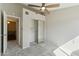 Bedroom featuring a ceiling fan, mirrored closet, and neutral carpet at 510 N Alma School Rd # 103, Mesa, AZ 85201