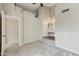 Spacious bedroom with lofted ceiling and a carpeted floor, featuring both a sink and vanity area at 510 N Alma School Rd # 103, Mesa, AZ 85201