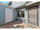 Entrance of the property with a secure screen door, concrete, and light blue siding at 510 N Alma School Rd # 103, Mesa, AZ 85201