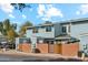 Exterior view of the blue townhome with brick wall and privacy gates at 510 N Alma School Rd # 103, Mesa, AZ 85201