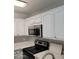 This is a bright kitchen with white cabinets and stainless steel appliances at 510 N Alma School Rd # 103, Mesa, AZ 85201