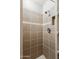 Shower features decorative tile and integrated toiletry shelf at 510 N Alma School Rd # 103, Mesa, AZ 85201