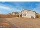 Gravel backyard offering a low-maintenance outdoor space with privacy fence and partial patio area at 5217 E Emery Rd, San Tan Valley, AZ 85143