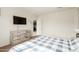 A bedroom with a dresser, TV, and a doorway leading to the kitchen at 5217 E Emery Rd, San Tan Valley, AZ 85143