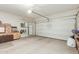 Spacious two car garage with overhead lighting and storage unit, perfect for parking and organization at 5217 E Emery Rd, San Tan Valley, AZ 85143