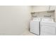 A laundry room featuring a washer and dryer with shelves for storage at 5217 E Emery Rd, San Tan Valley, AZ 85143