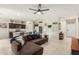 Inviting living room showcasing modern decor, tile flooring, and an open layout connecting to the kitchen at 5217 E Emery Rd, San Tan Valley, AZ 85143