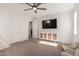 Neutral bedroom featuring a ceiling fan, television, and seating area for a comfortable and relaxing space at 5460 S Dillon Cir, Mesa, AZ 85212