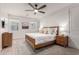 Bright bedroom featuring a wooden bed frame, night stands, dresser, and large windows for ample natural light at 5460 S Dillon Cir, Mesa, AZ 85212