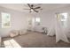 Spacious bedroom filled with natural light, featuring a ceiling fan and an ensuite bathroom at 5460 S Dillon Cir, Mesa, AZ 85212