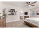 Bedroom featuring shelves, a dresser, a television, and a walk through to the en suite bathroom at 5460 S Dillon Cir, Mesa, AZ 85212