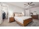 This bedroom has neutral walls, a light brown bed frame, and light-colored bedding with two small nightstands at 5460 S Dillon Cir, Mesa, AZ 85212