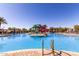 Community pool with a fun water slide, palm trees, and lounge chairs for relaxing and enjoying the sun at 5460 S Dillon Cir, Mesa, AZ 85212