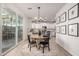 Bright dining area with sliding glass doors for indoor/outdoor living and modern lighting fixture at 5460 S Dillon Cir, Mesa, AZ 85212