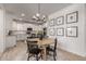 Bright dining area with round table, modern chandelier, and seamless flow to kitchen at 5460 S Dillon Cir, Mesa, AZ 85212