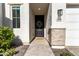 Inviting front entrance with a decorative wreath, stylish lighting and brick accents at 5460 S Dillon Cir, Mesa, AZ 85212