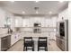 Modern kitchen boasts white cabinetry, stainless steel appliances, an island with seating, and stylish finishes at 5460 S Dillon Cir, Mesa, AZ 85212