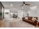 Spacious living area flowing into an open kitchen and dining space with modern finishes at 5460 S Dillon Cir, Mesa, AZ 85212