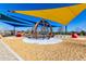 Fun playground area with colorful shade structures and engaging play equipment for children at 5460 S Dillon Cir, Mesa, AZ 85212