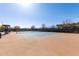 Outdoor tennis court with blue playing surface surrounded by fencing at 5460 S Dillon Cir, Mesa, AZ 85212