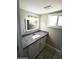 Bathroom vanity features granite countertop, modern lighting and mirror at 6029 S 6Th Ave, Phoenix, AZ 85041