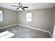 Cozy bedroom with tile floors, light grey walls, ceiling fan, and a bright window for ample natural light at 6029 S 6Th Ave, Phoenix, AZ 85041