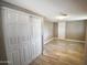 Neutral bedroom featuring a large closet, tile floors, light grey walls, and a white door at 6029 S 6Th Ave, Phoenix, AZ 85041