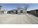 Charming single-story home featuring a low-pitched roof, white stucco, dark trim and a large front yard at 6029 S 6Th Ave, Phoenix, AZ 85041