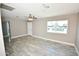 Spacious living room featuring sleek tile floors, grey walls, a ceiling fan, and a bright double window at 6029 S 6Th Ave, Phoenix, AZ 85041