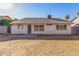 The backyard features a patio, block fence, and desert landscaping at 6132 E Casper St, Mesa, AZ 85205