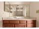 Bathroom featuring a vanity with a sink, mirror and wooden cabinets at 6132 E Casper St, Mesa, AZ 85205