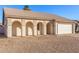 Charming single-story home featuring a two-car garage, low maintenance yard, and covered front entry with arched features at 6132 E Casper St, Mesa, AZ 85205