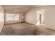 Spacious living room featuring vaulted ceilings, neutral walls, a ceiling fan, and a large window for ample natural light at 6132 E Casper St, Mesa, AZ 85205