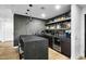 Elegant bar area featuring dark countertops, open shelving, wine refrigerator and modern pendant lighting at 7147 E Rancho Vista Dr # 6011, Scottsdale, AZ 85251