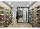 Long view of a temperature-controlled wine cellar showcasing custom wine racks and glass doors at 7147 E Rancho Vista Dr # 6011, Scottsdale, AZ 85251