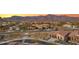 Aerial view of homes in a desert community with mountain views at sunset at 7165 S Bruins Rd, Gold Canyon, AZ 85118