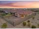 Aerial view of the backyard with desert landscaping, block wall, and covered patio at 7165 S Bruins Rd, Gold Canyon, AZ 85118