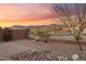 Backyard with desert landscaping, block wall, and mountain views at 7165 S Bruins Rd, Gold Canyon, AZ 85118