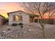 Backyard with desert landscaping and sliding glass door to covered patio at 7165 S Bruins Rd, Gold Canyon, AZ 85118