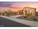 A single-Gathering home showing an attached two car garage and a beautifully landscaped yard at 7165 S Bruins Rd, Gold Canyon, AZ 85118