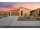 Well maintained front yard with desert landscaping and an attached two car garage at 7165 S Bruins Rd, Gold Canyon, AZ 85118