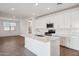 Bright kitchen featuring white cabinets, subway tile backsplash, stainless steel appliances, and a large island at 7165 S Bruins Rd, Gold Canyon, AZ 85118