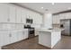 Bright kitchen with white cabinets, subway tile backsplash, stainless steel appliances, and center island at 7165 S Bruins Rd, Gold Canyon, AZ 85118